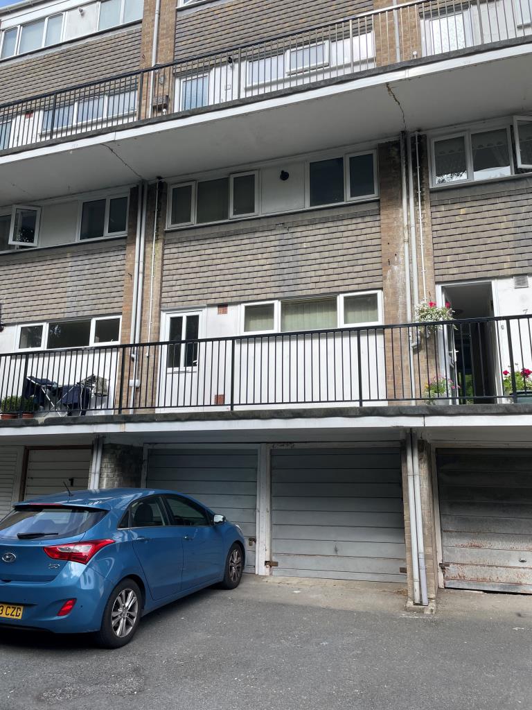 Lot: 104 - TWO-BEDROOM MAISONETTE WITH GARAGE - Rear view of flat showing entrance and garage